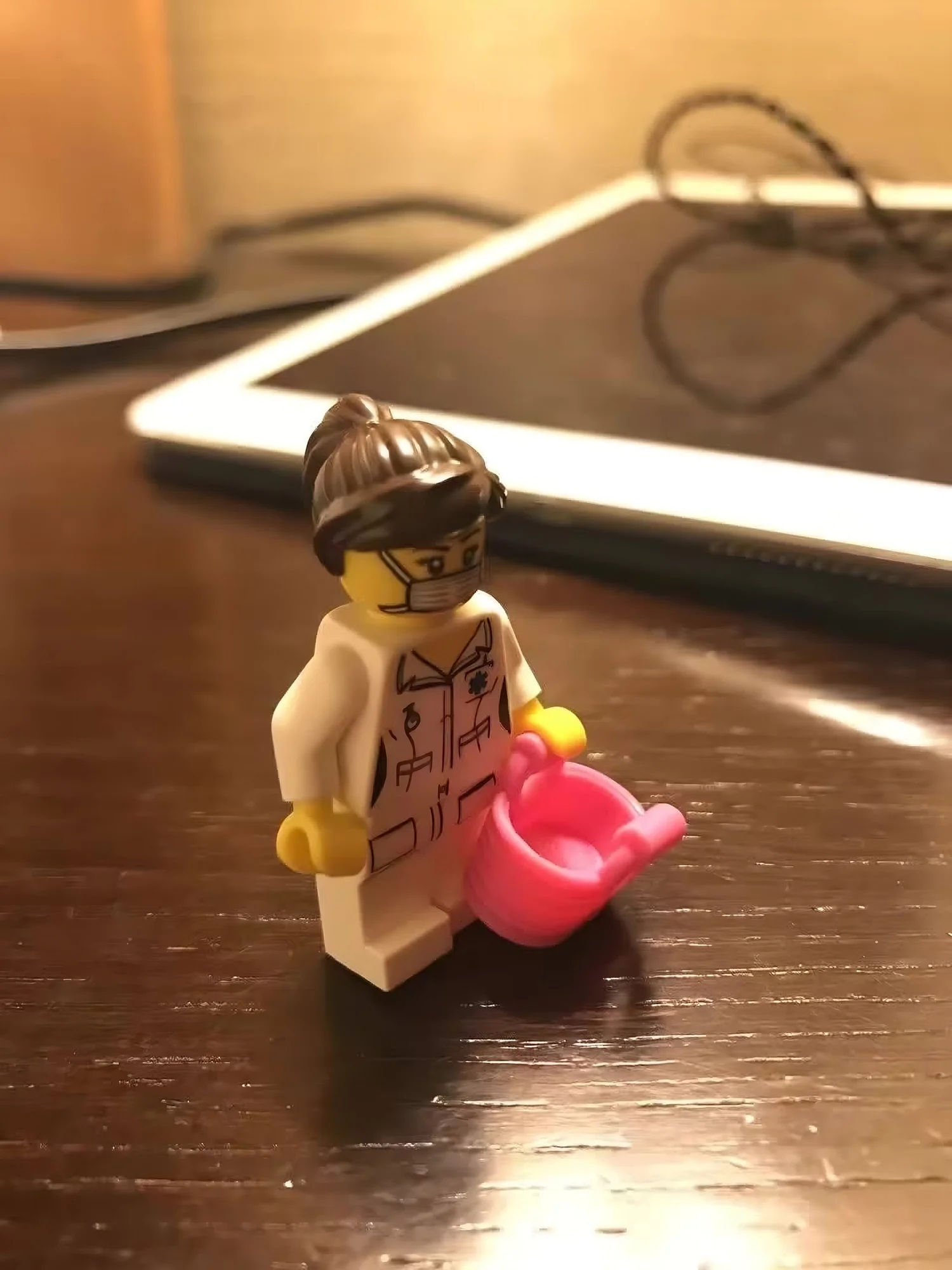 A toy doctor figure holding eyeglasses